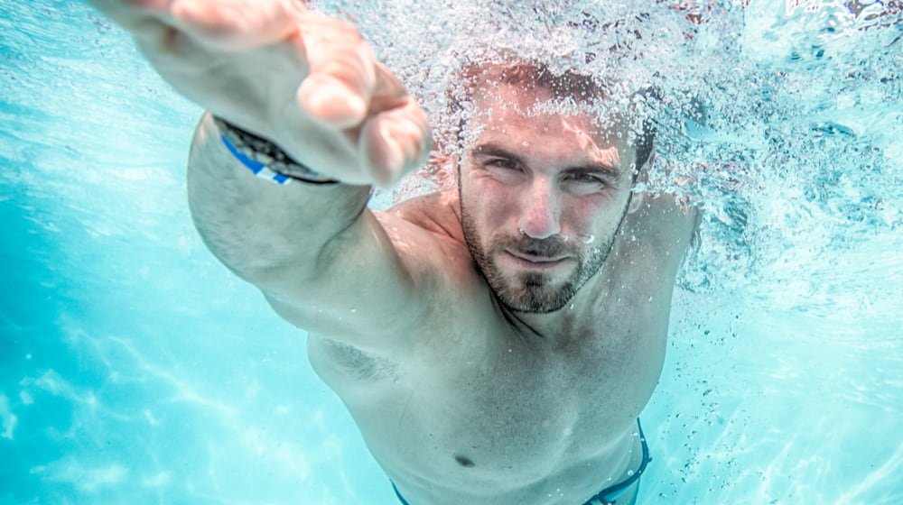 man swimming Is It Safe To Swim With Contact Lenses