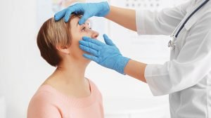 Ophthalmologist-examining-eyes-of-mature-woman-in-clinic---What-Causes-Eye-Floaters-and-Flashes---ss-feat
