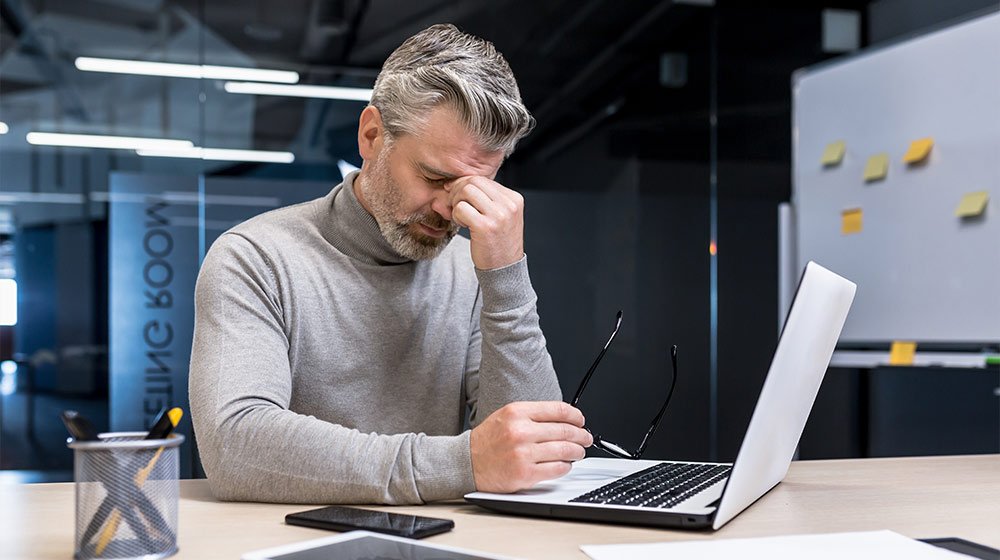 businessman-overtired-working-on-laptop-Diabetic-Retinopathy-ss-feat